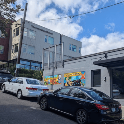 The Portland International School with cars parked on the road