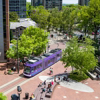 Portland streetcar crosses the PSU Urban Plaza on a spring day