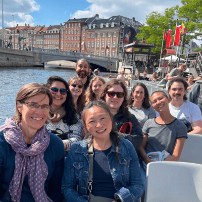 A group photo of study abroad participants in a boat