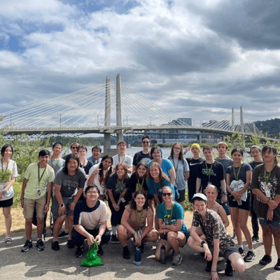 Students in the 2023 summer camp pose for a group photo in front of Portland's Tilikum Crossing bridge
