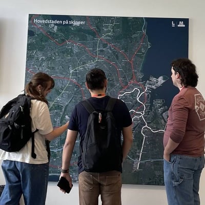 Students look at a transit map posted on a wall.