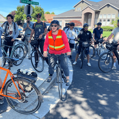 Participants in the 2024 workshop ride bikes on a field tour